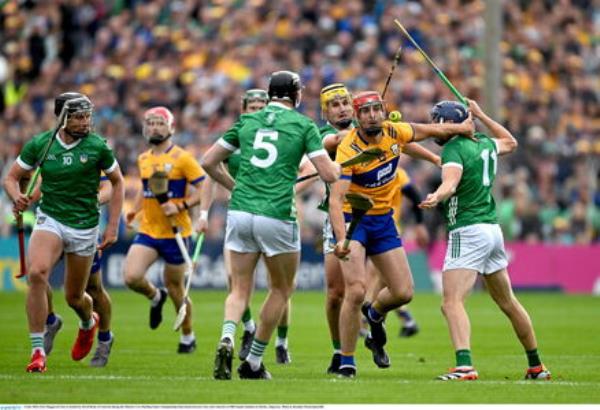 Peter Duggan of Clare is tackled by David Reidy of Limerick. Pic: Brendan Moran/Sportsfile