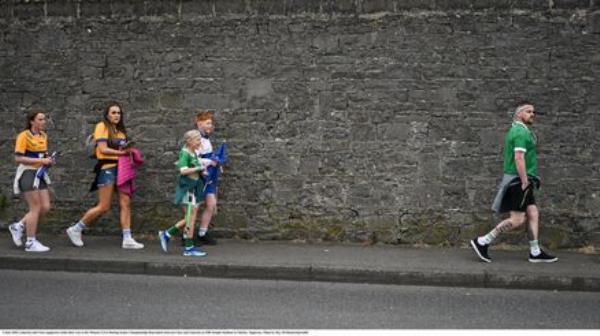 Limerick and Clare supporters make their way to the Munster final in Thurles. Pic: Ray McManus/Sportsfile