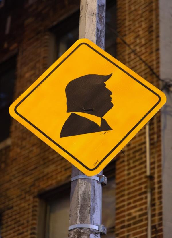 Unofficial yellow Do<em></em>nald Trump street signs displayed at the intersection of 92nd St. and Gatling Place in New York City