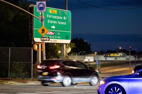 Trump signs at the intersection of 92nd St. and Gatling Place, near the entrance ramp to the Verrazzano-Narrows Bridge in New York City, October 1, 2024